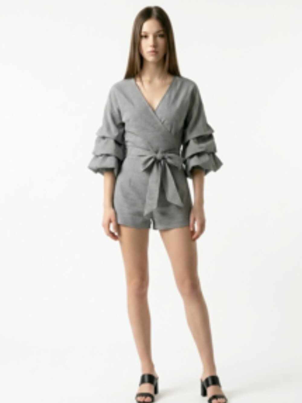 grey romper features a sophisticated V-neckline